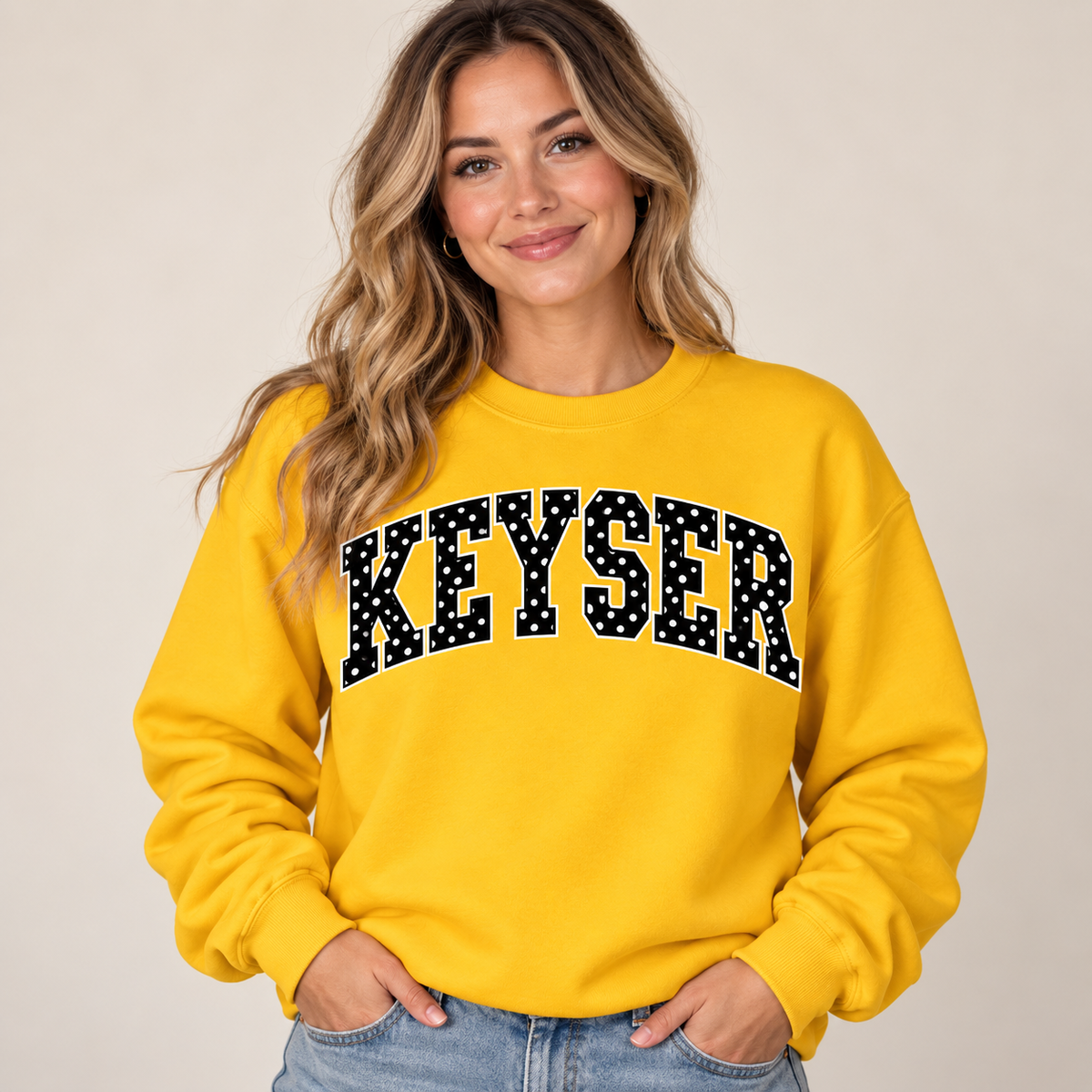 Woman wearing gold Keyser polka dot crewneck