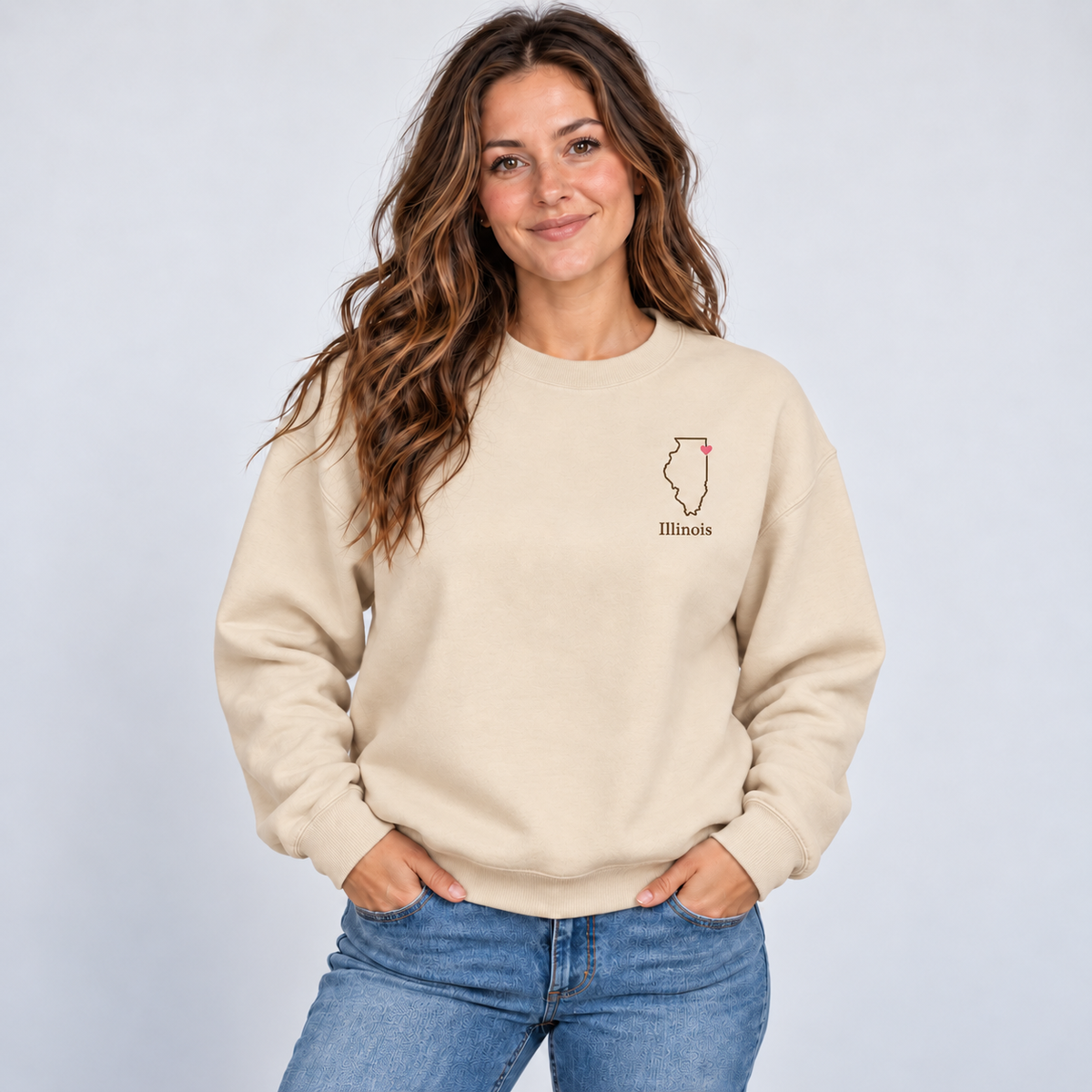 Illinois minimal hometown outline and pink heart on a Gildan G180 Sand crewneck