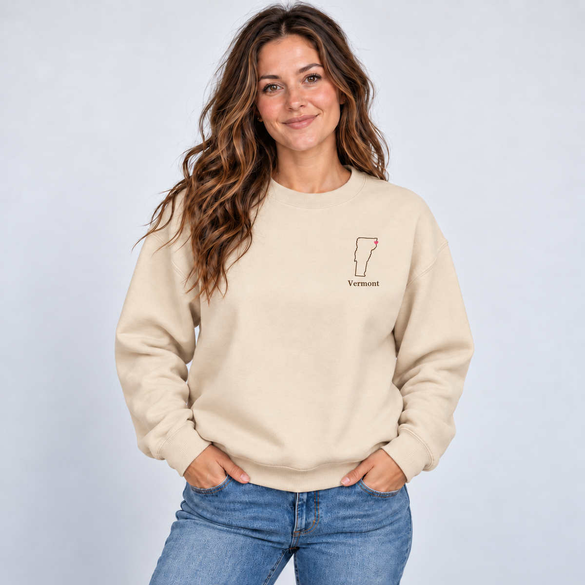 Vermont minimal hometown outline and pink heart on a Gildan G180 Sand crewneck