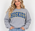 Model wearing heather gray HUSKIES polka dot crewneck