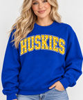 Model wearing royal blue HUSKIES polka dot crewneck