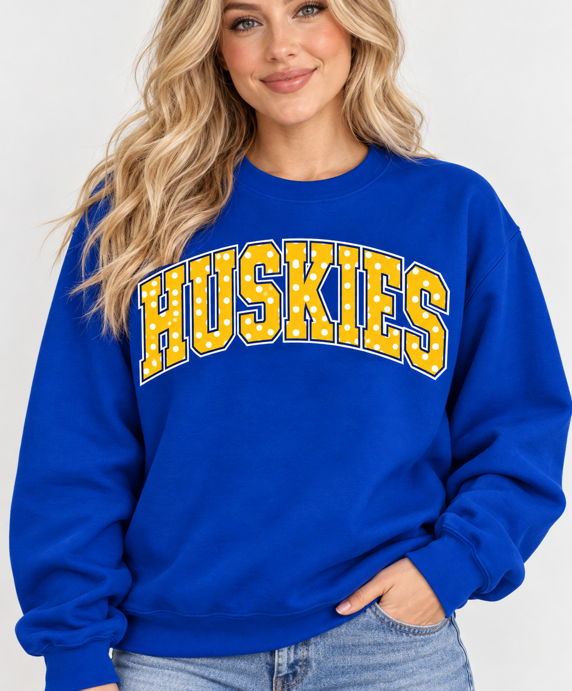 Model wearing royal blue HUSKIES polka dot crewneck